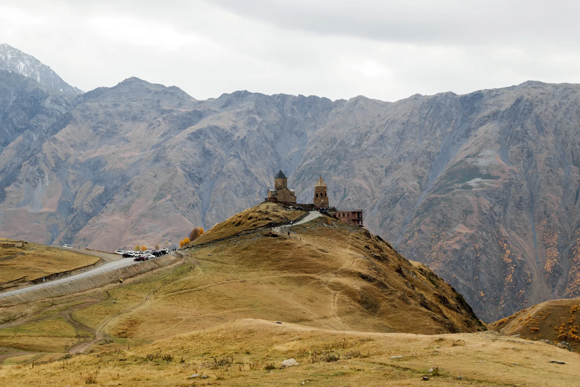Gergeti Trinity Church surrounded by autumn colors in the Caucasus mountains