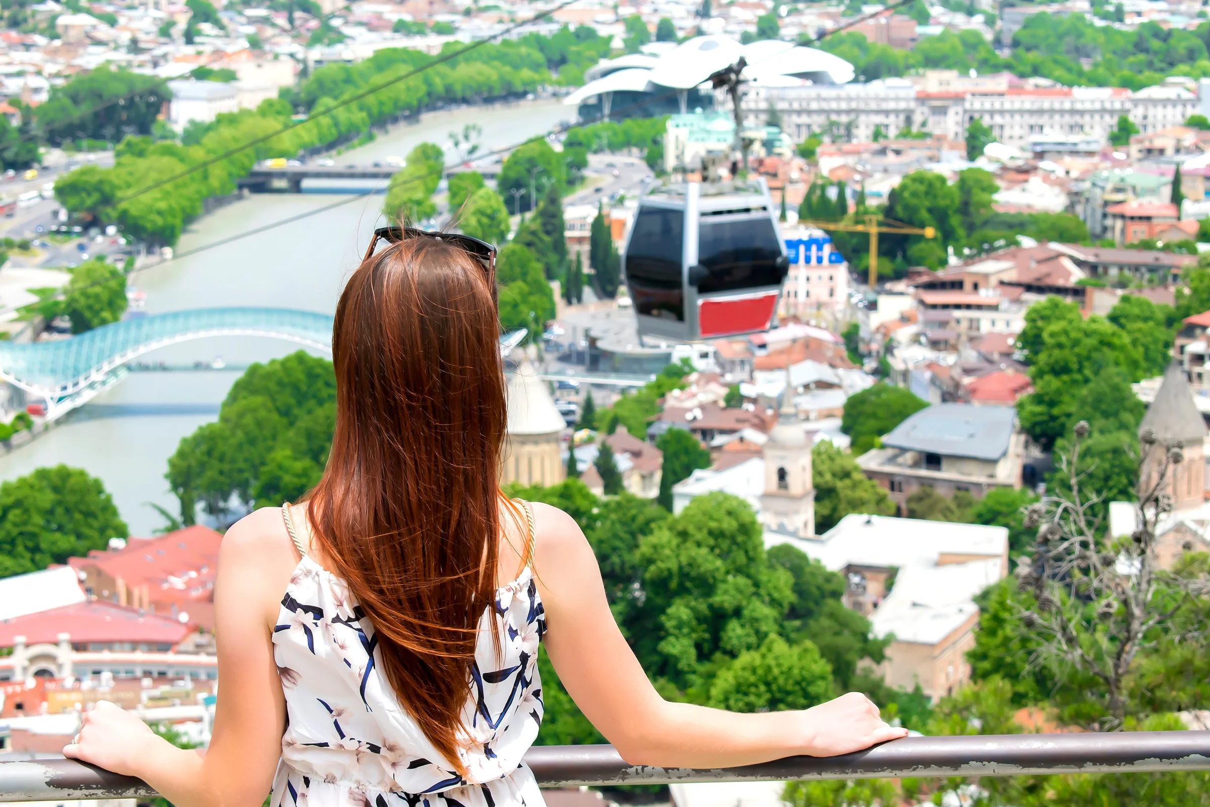 Traveler looking out over the Tbilisi panorama from a hilltop viewpoint