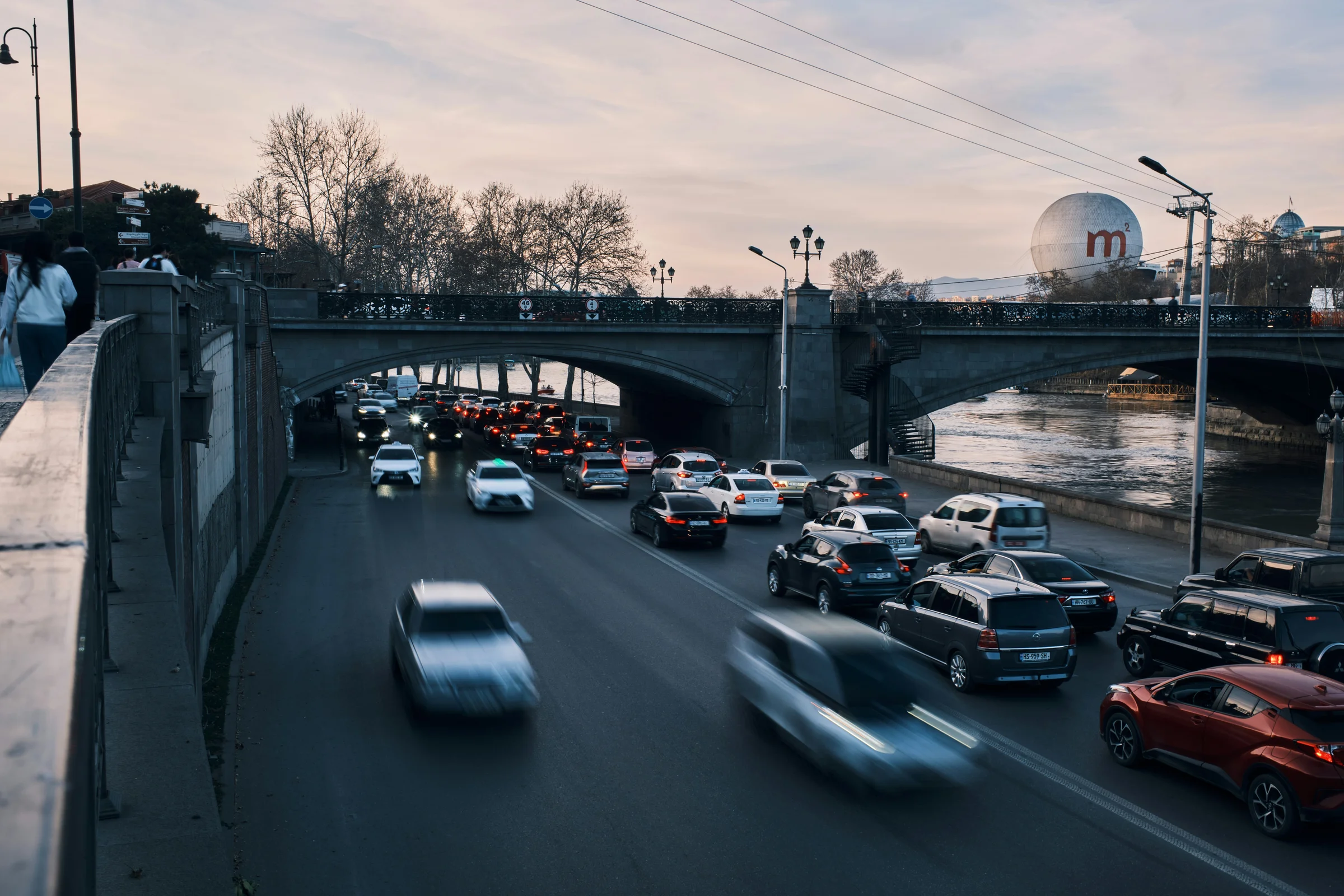 Traffic flowing through central Tbilisi along the Kura River