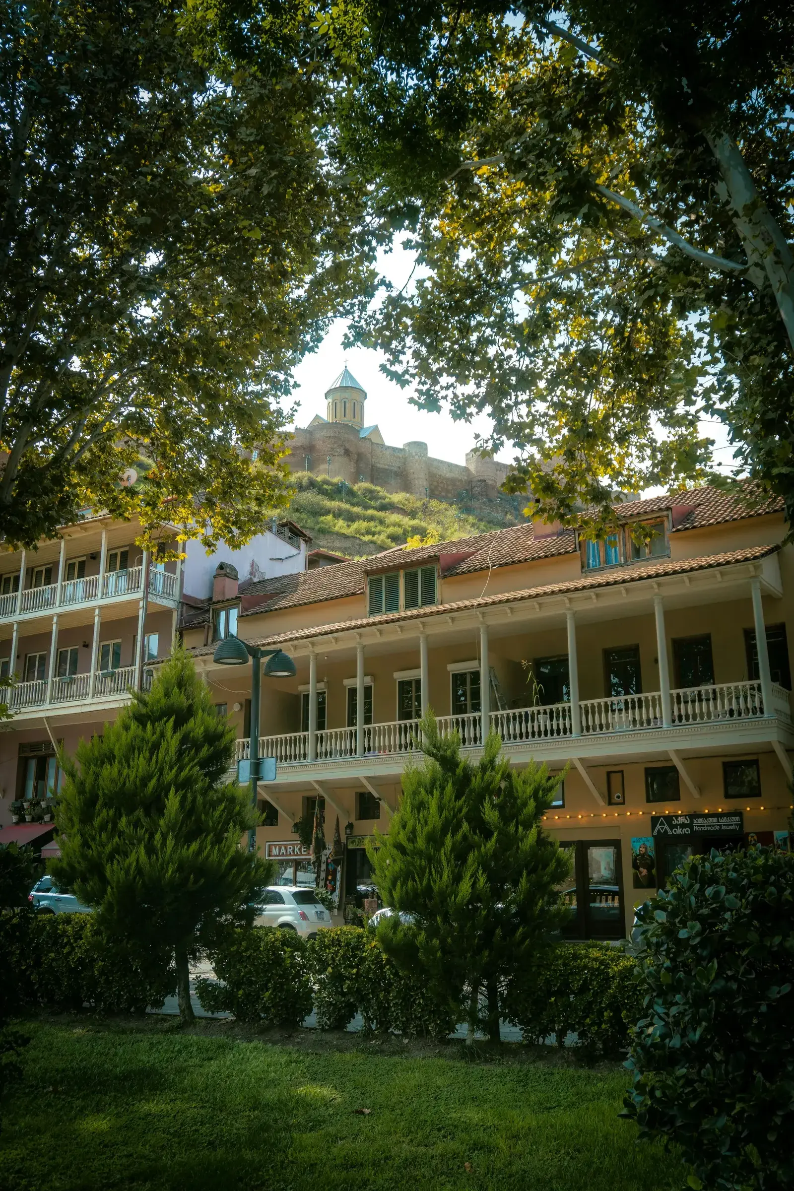 Cobblestone street in Tbilisi's old town with traditional wooden balconies