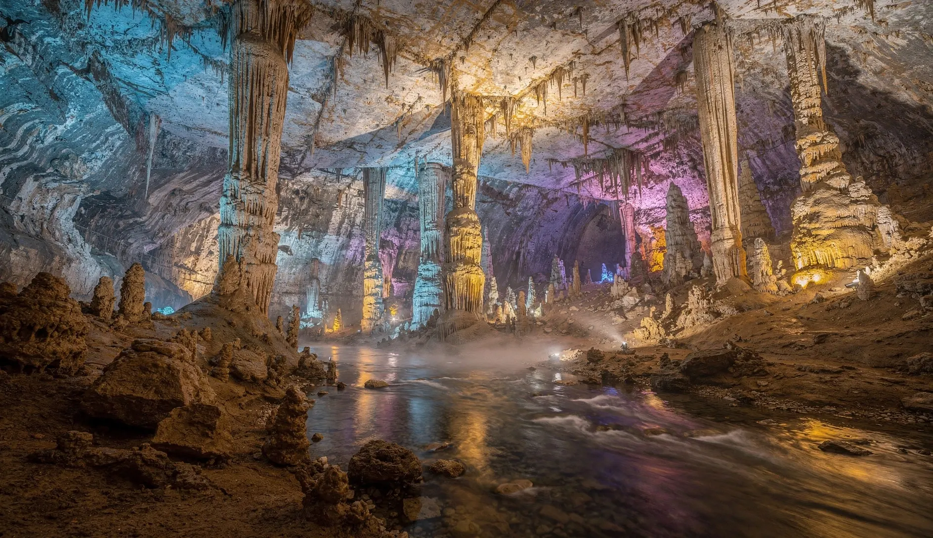 Illuminated stalactites and stalagmites inside Prometheus Cave near Kutaisi, Georgia