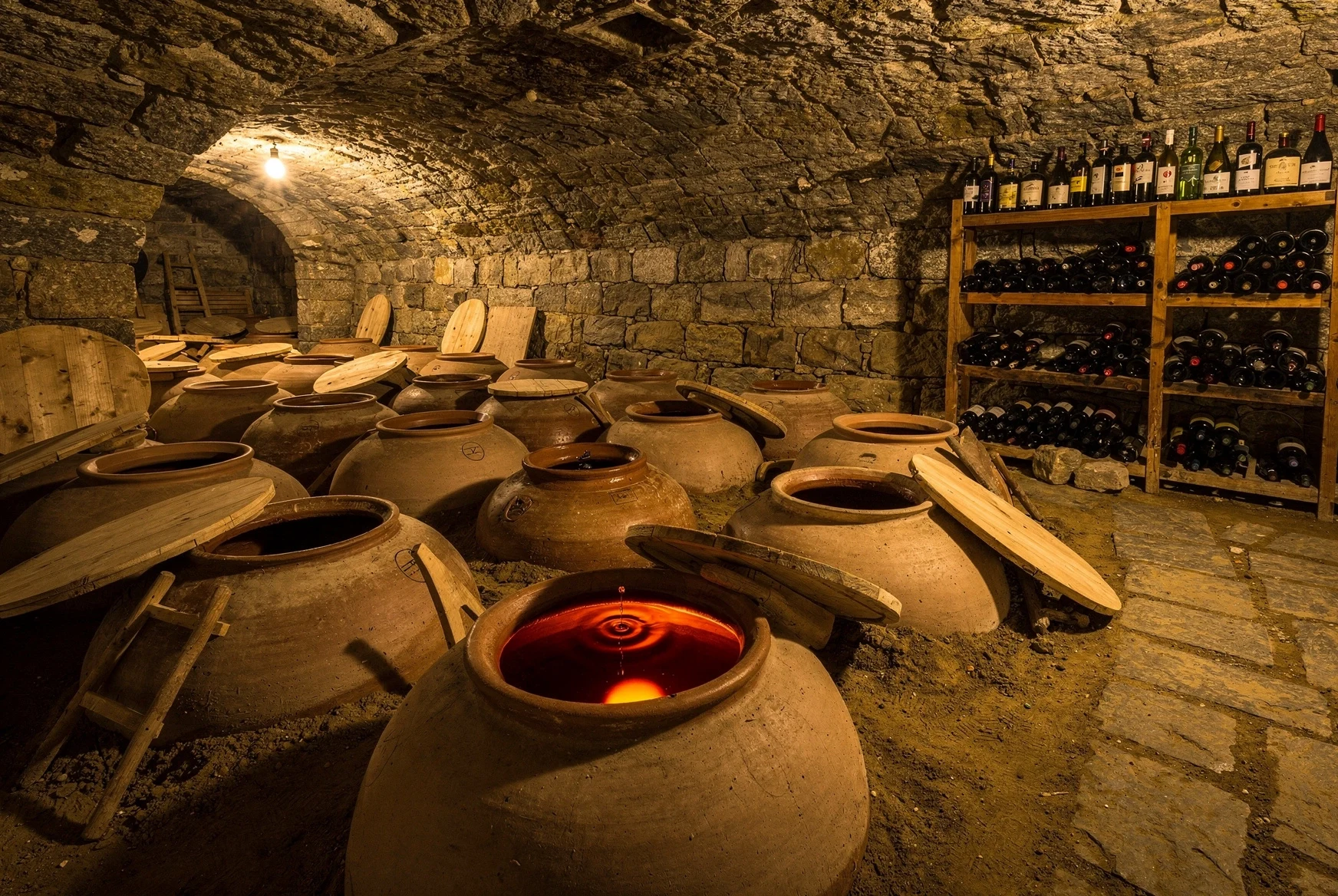 Traditional Georgian marani cellar with qvevri buried in the floor