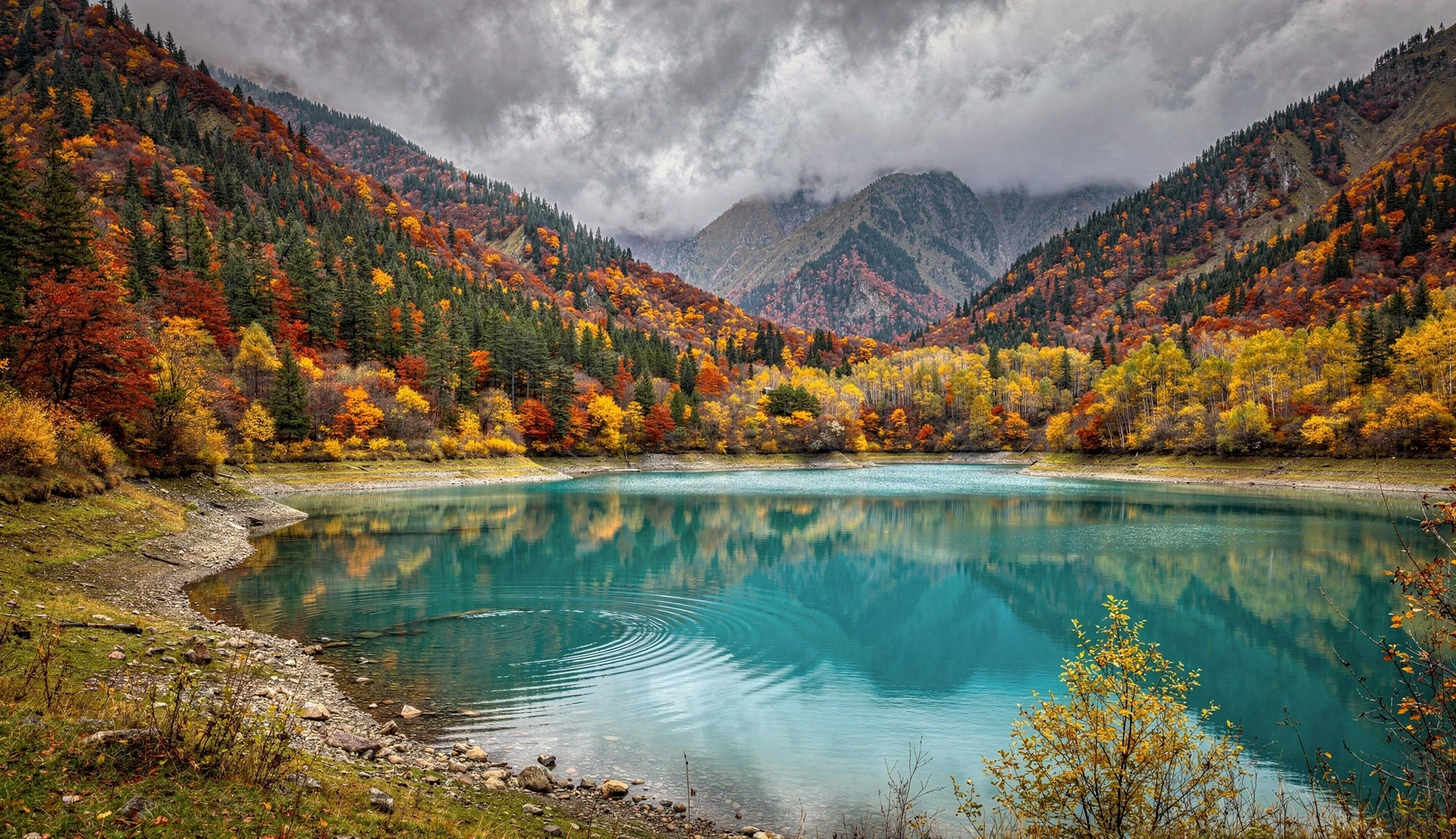 Turquoise mountain lake surrounded by autumn forest in Racha