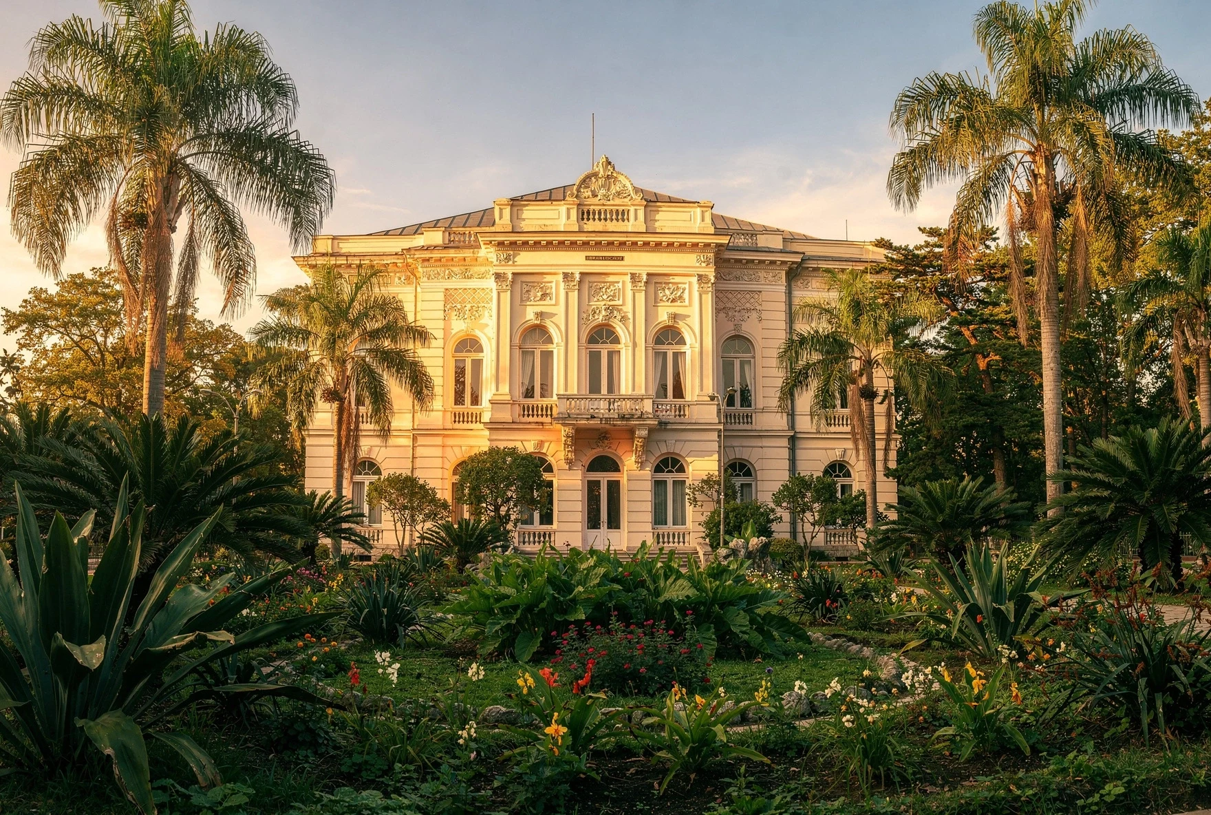 The Dadiani Palace in Zugdidi surrounded by lush botanical gardens with palm trees
