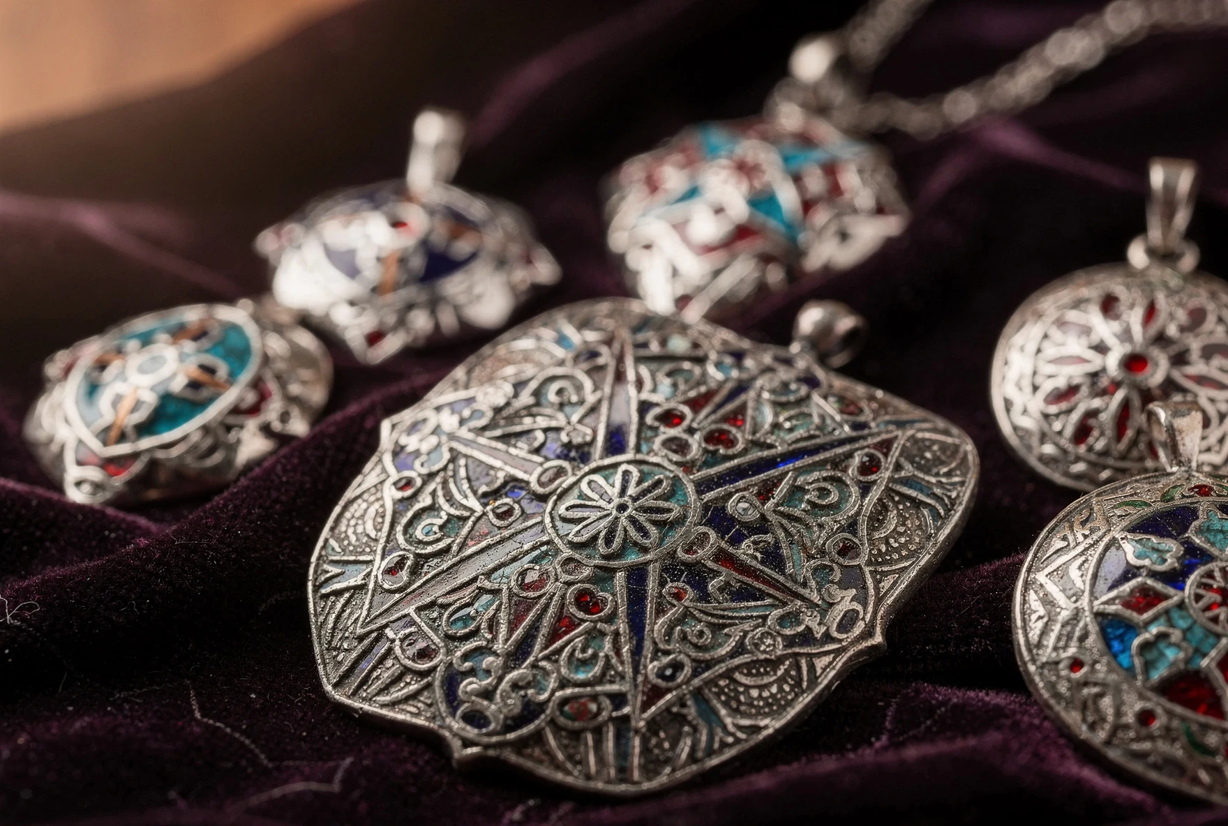 Traditional Georgian cloisonné enamel jewelry pieces with intricate silver filigree and colourful enamel inlays