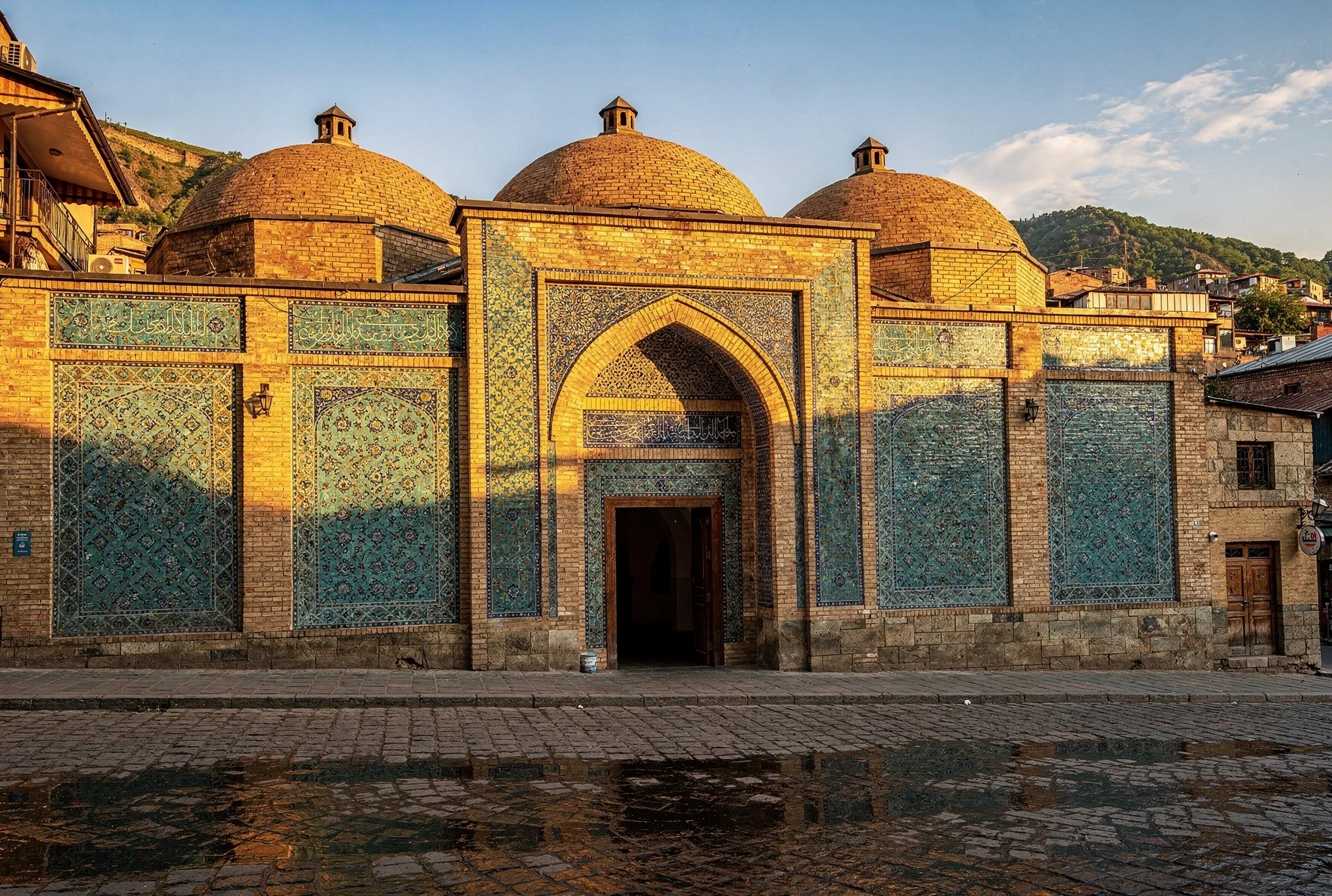 Ornate blue and turquoise tiled facade of a sulfur bathhouse in Abanotubani, Tbilisi