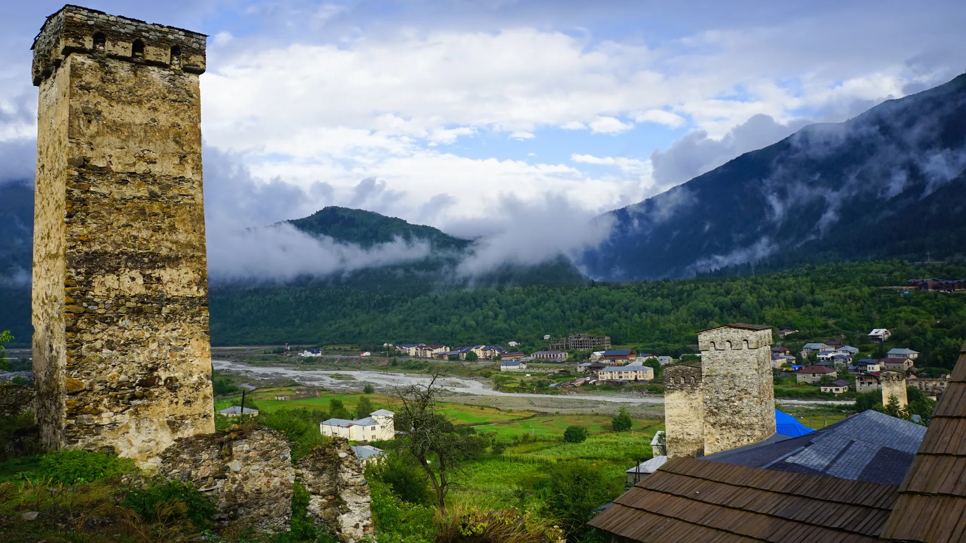 Historic Mestia town in Svaneti with medieval stone defensive towers and the Caucasus mountains behind