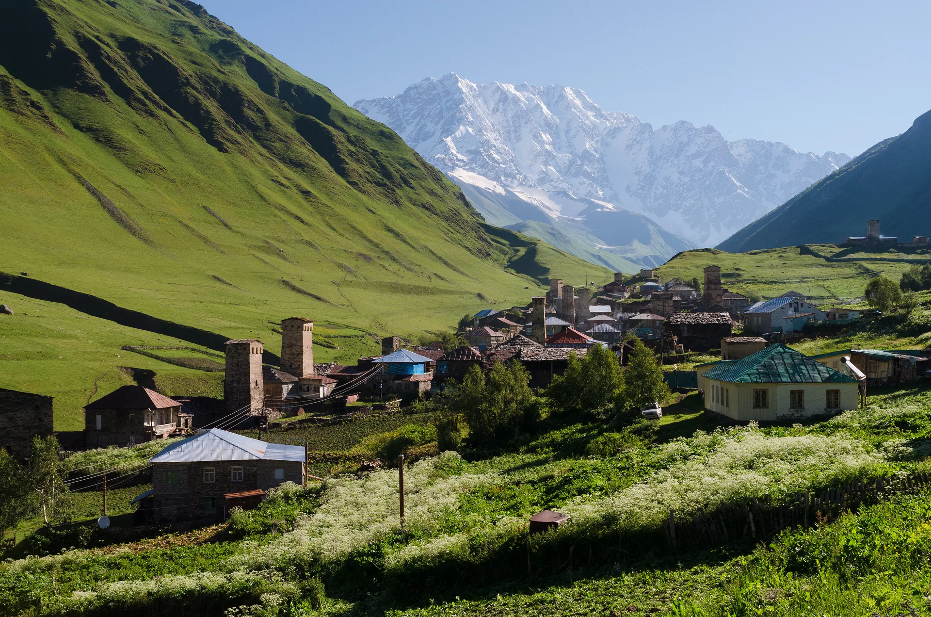 The medieval village of Ushguli with its ancient Svan towers beneath snow-capped mountains in Upper Svaneti, Georgia