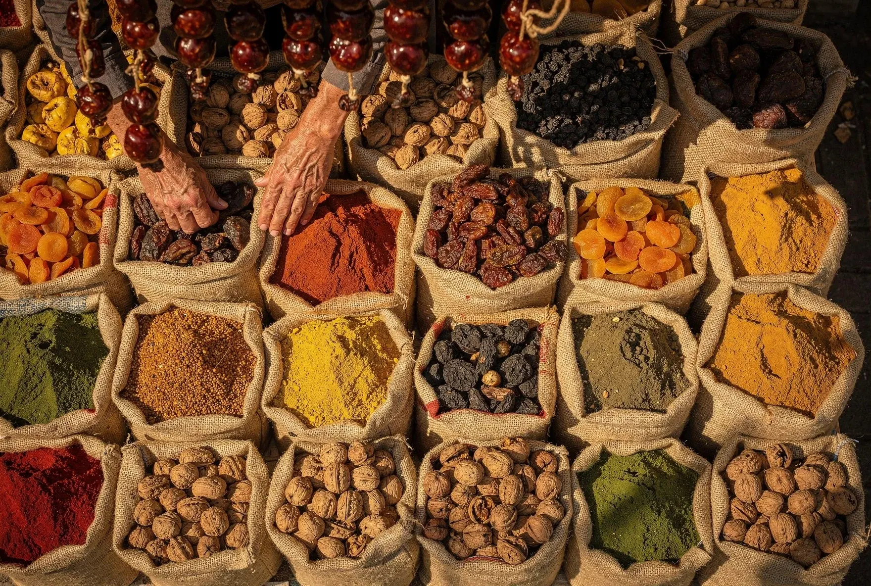 Georgian market stall with colorful spices, dried fruits, and churchkhela