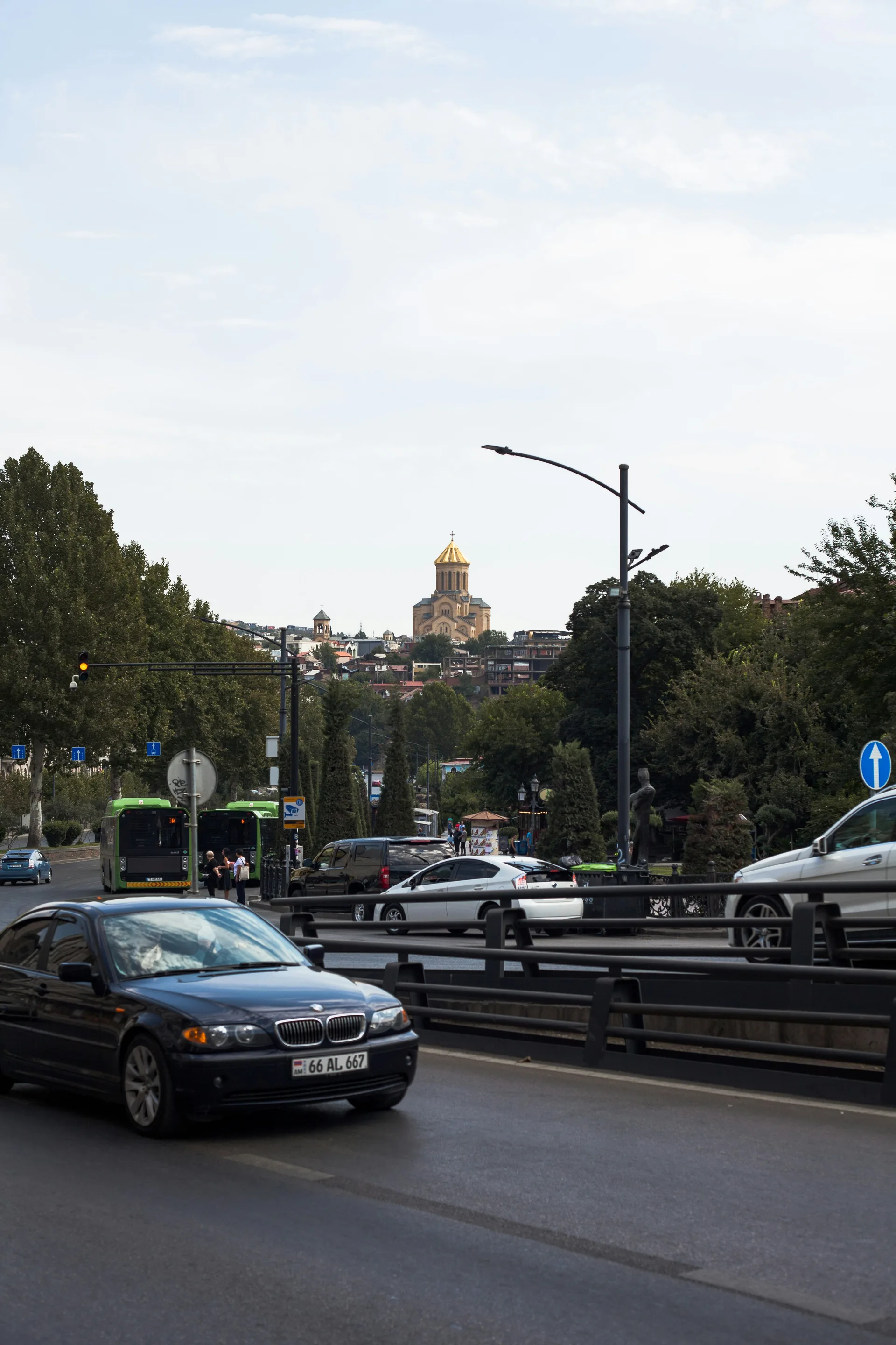 Driving through Tbilisi with Holy Trinity Cathedral on the hilltop